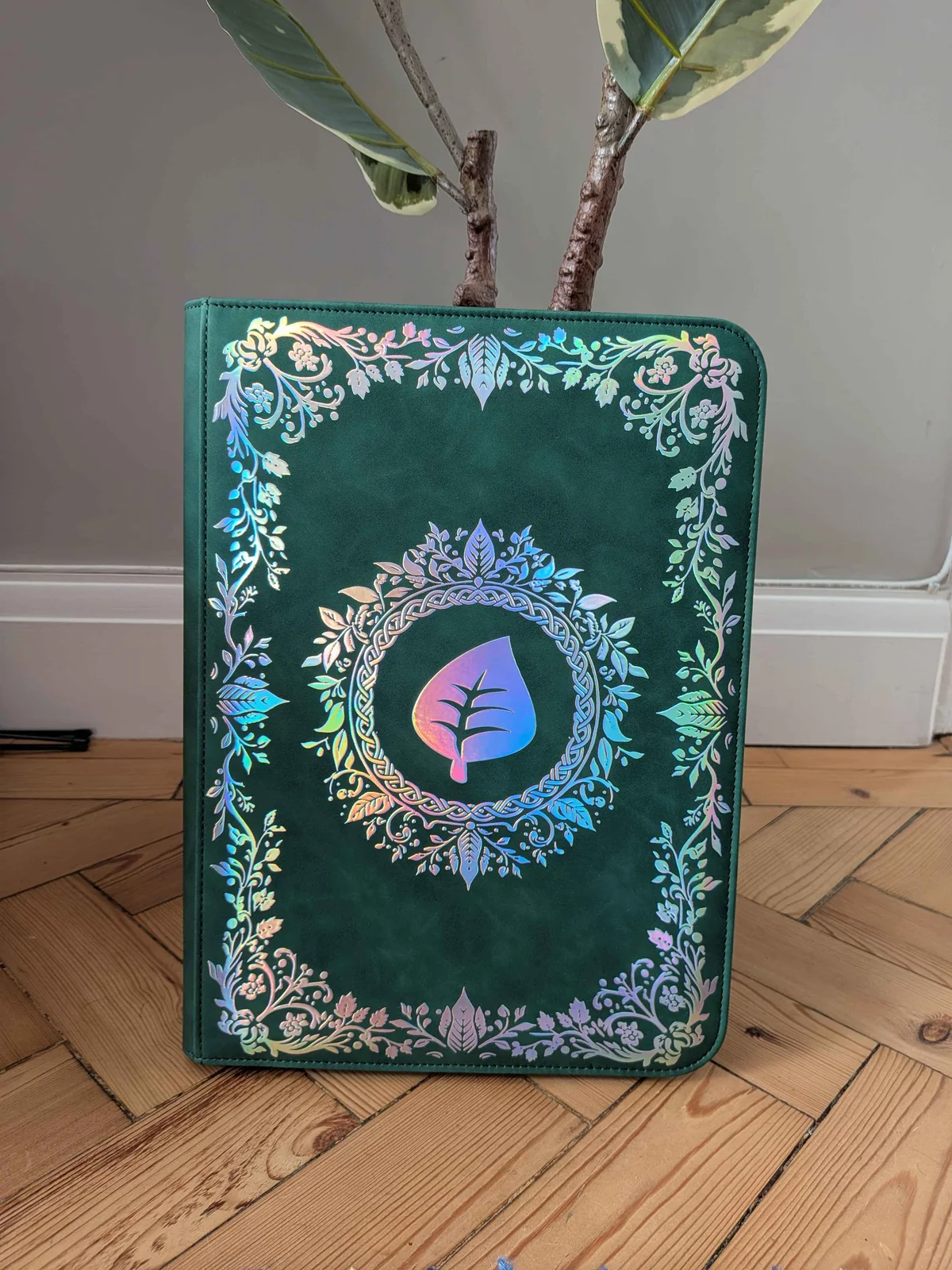 Iron Root binder beside a houseplant on a wooden floor