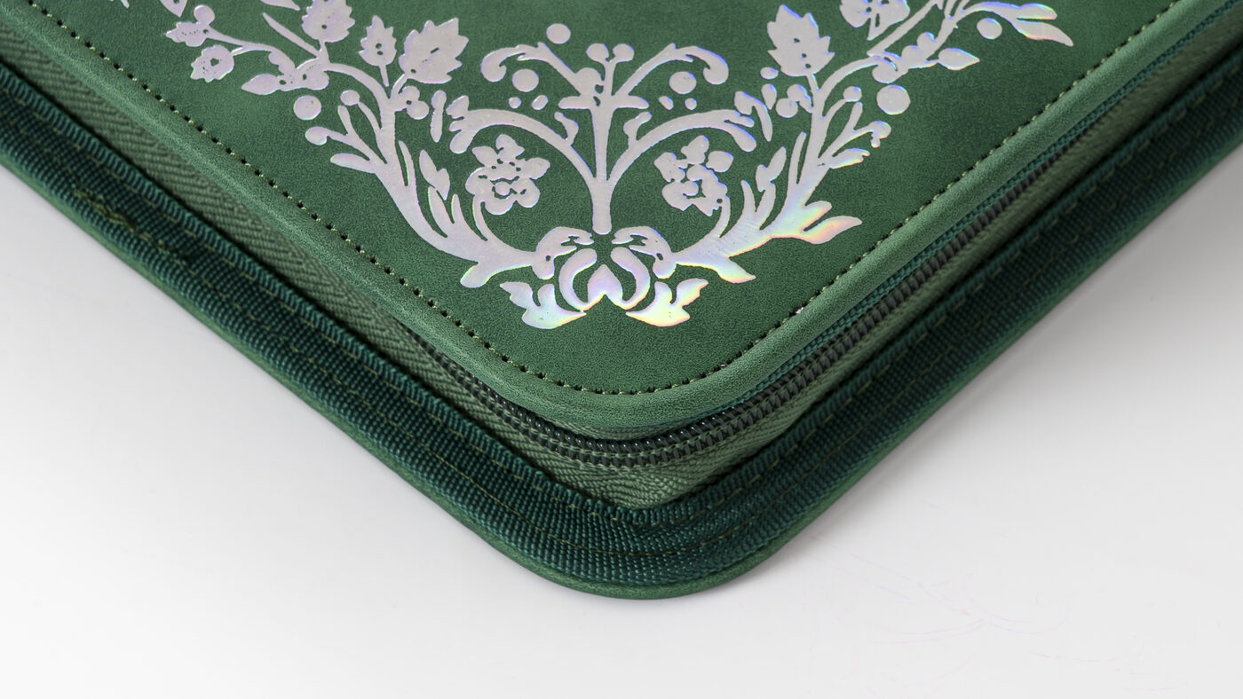 Close view of the Iron Root binder's stitched edge and textured exterior