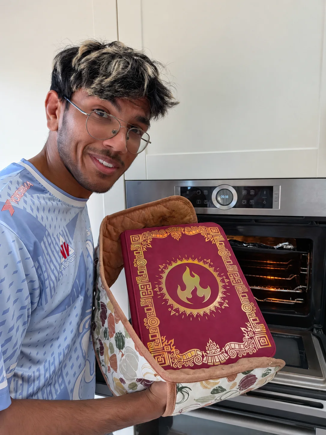 Adi playfully holding the Sunfire binder by an oven